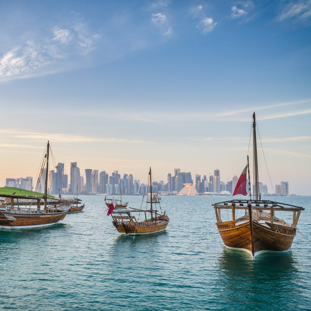 Luxury yacht at sunset on the Arabian Gulf, Doha skyline